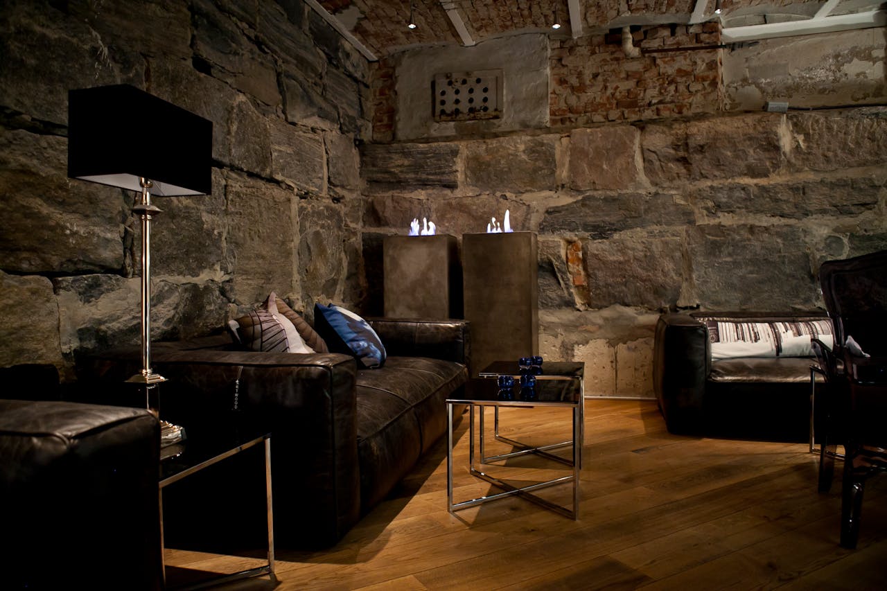 Elegant living room featuring rustic stone walls and modern furniture design.